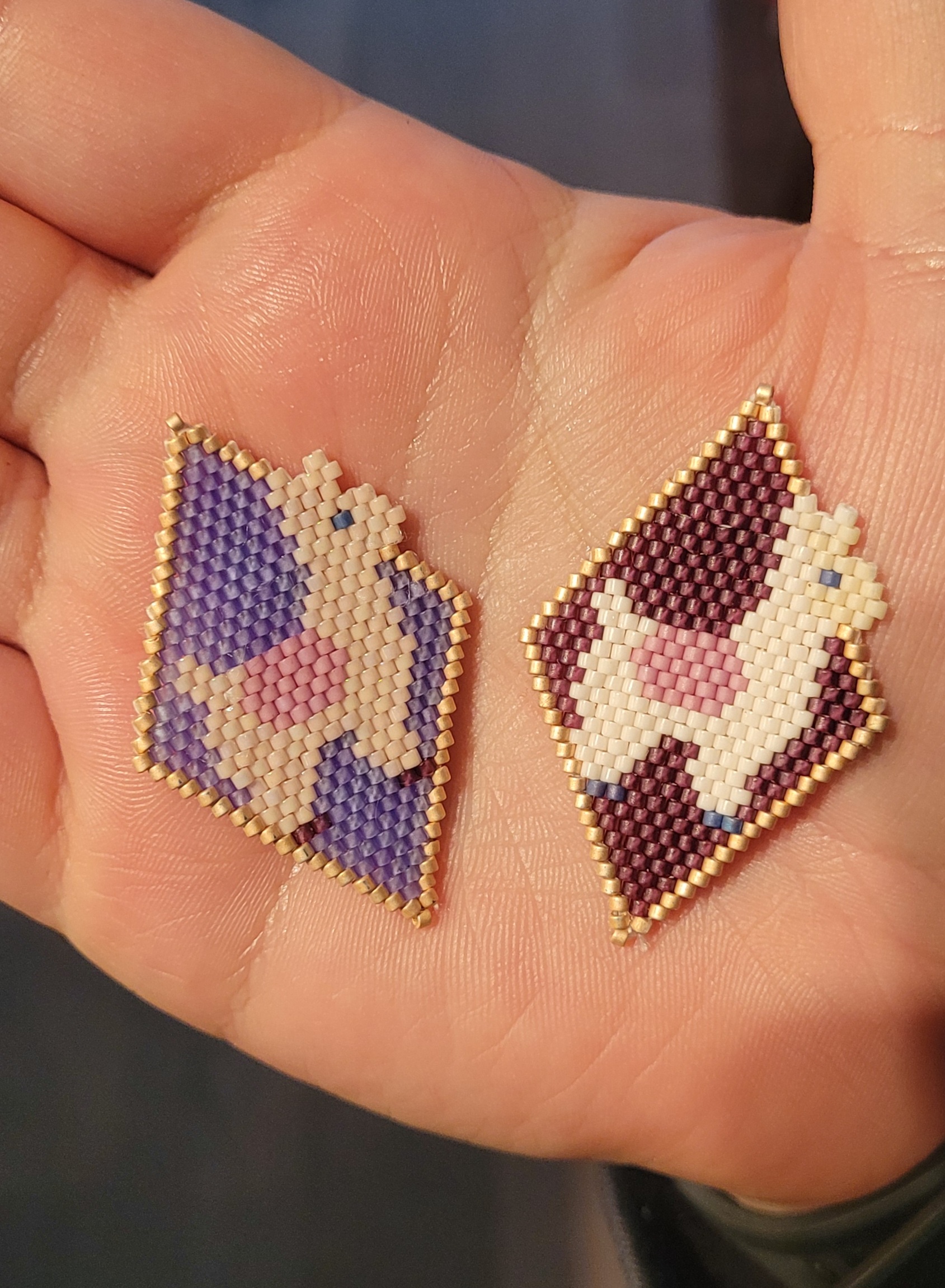 two beaded alpacas (using brick stitch) inside coloured diamonds; yes, llamas are different from alpacas