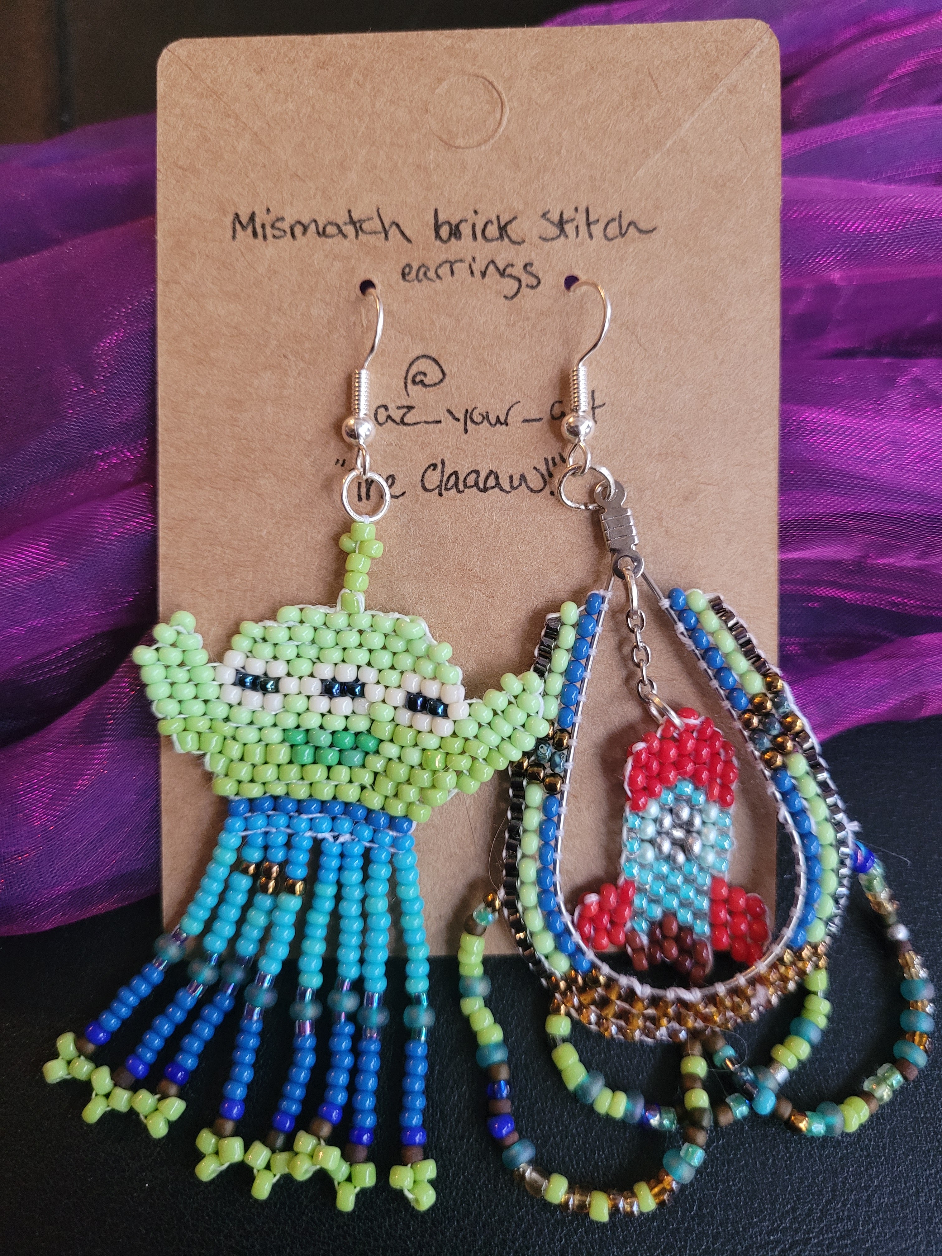 a-symmetrical beaded earrings resembling the green, three-eyed aliens from Toy Story, and their rocket ship